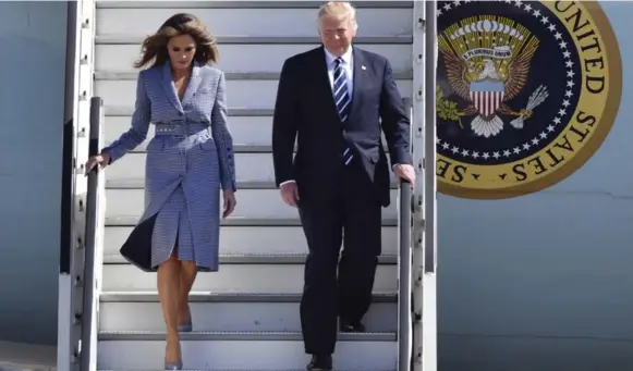  ?? GEERT VANDEN WIJNGAERT/THE ASSOCIATED PRESS ?? No one would call Melania and Donald Trump a touchy-feely couple. They are shown here maintainin­g a hands-off policy as they arrive in Melsbroek, Belgium, on Wednesday.