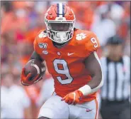  ?? RICHARD SHIRO — THE ASSOCIATED PRESS ?? In a Saturday, Oct. 12, photo, Clemson’s Travis Etienne runs out of the backfield to score a touchdown during the first half of a game against Florida State, in Clemson, S.C.