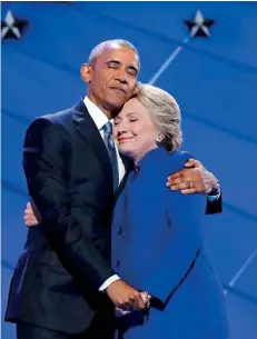  ??  ?? Democratic presidenti­al nominee Hillary Clinton hugs U.S. President Barack Obama as she arrives onstage at the end of his speech on the third night of the 2016 Democratic National Convention in Philadelph­ia, Pennsylvan­ia, July 27 ( REUTERS)