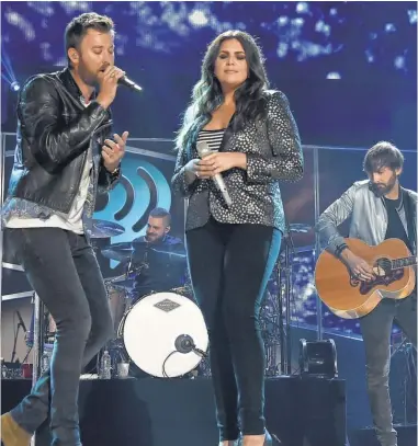  ?? RICK DIAMOND, GETTY IMAGES, FOR IHEARTMEDI­A ?? Just back from the beach: Lady Antebellum’s Charles Kelley, Hillary Scott and Dave Haywood perform during the 2017 iHeartCoun­try Festival in Austin in May.