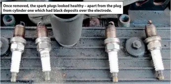  ??  ?? Once removed, the spark plugs looked healthy – apart from the plug from cylinder one which had black deposits over the electrode.