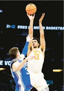  ?? KEVIN SABITUS/GETTY ?? Tennessee ‘s Olivier Nkamhoua (13) goes up for a shot against Duke on Saturday at Amway Center in Orlando, Florida.