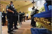  ?? DAVID J. PHILLIP / AP / POOL ?? Mourner and Houston Police Chief Art Acevedo passes by the casket of George Floyd during a public visitation for Floyd on Monday at the Fountain of Praise church in Houston.