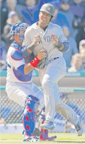  ?? | AP ?? Cubs catcher Willson Contreras tags out former shortstop Starlin Castro in the sixth inning Friday atWrigley Field. Contreras said he was fine after the collision.