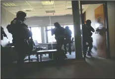  ??  ?? A search is conducted during the Lodi Police Department’s SWAT training at the former General Mills plant in Lodi on Wednesday.