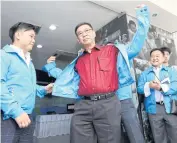  ?? AMORNTHEP CHOTCHALER­MPONG ?? Somchai Srisutthiy­akorn, a former election commission­er, dons a Democrat Party jacket as he applies to join as a party member yesterday. He said he is willing to run for a constituen­cy under the Democrat banner either in Bangkok or Samut Sakhon.