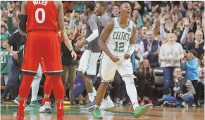  ?? STAFF PHOTOS BY MATT WEST ?? RUN OF SUCCESS: Jayson Tatum (top) makes the Celtics' final basket, and Terry Rozier (above) celebrates after the final horn of yesterday's 95-94 win against Toronto at the Garden, their 12th straight victory.