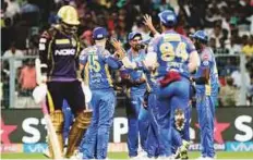  ?? AP ?? Kolkata Knight Riders’ Sunil Narine (left) trudges off the pitch after being dismissed as Rajasthan Royals’ players celebrate.