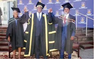  ?? ?? President Mnangagwa poses with best students and recipients of the Emmerson Dambudzo Mnangagwa Chancellor’s Awards, Munashe Gahadza (right) and Gamuchirai Bhiza during the University of Zimbabwe graduation ceremony in Harare yesterday.