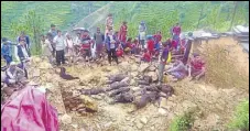  ?? RAMESHWAR GAUR/HT ?? Villagers assess the damage after a wall collapsed in a remote village in Pauri Garhwal on Saturday morning.