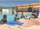  ?? PHOTOS BY ADRIAN MARSH/THE REPUBLIC ?? Children learn to swim while taking lessons at a Phoenix YMCA on Tuesday.