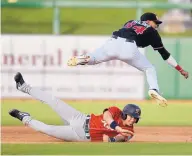  ?? ROBERTO E. ROSALES/JOURNAL ?? Albuquerqu­e second baseman Nelson Molina, top, leaps over Tacoma’s Joe Lobaton en route to completing a double play Friday night at Isotopes Park.