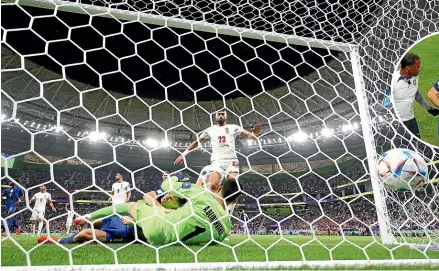  ?? GETTY IMAGES ?? US striker Christian Pulisic collides heavily with Iran goalkeeper Alireza Beiranvand moments after scoring the matchwinni­ng goal yesterday. He was later taken from the field, inset, to receive hospital treatment for a pelvic contusion.