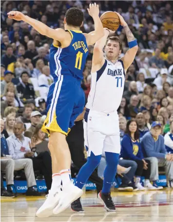  ?? — AP ?? Dallas Mavericks’ Luka Doncic (right) in action against Klay Thompson of Golden State Warriors in their NBA basketball game in Oakland, California, on Saturday.