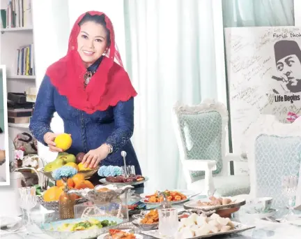  ??  ?? Gracious host Yenny Wahid continues her late father's tradition of having an open house during Eid al-fitr