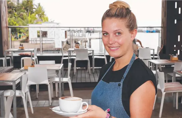  ?? Picture: JUSTIN BRIERTY ?? ALL SET: Barista Kyra Kunkel from Wharf One cafe, that neighbours the cruise ship terminal, is looking forward to the proposed work on Trinity Inlet.