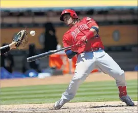  ?? John G. Mabanglo European Pressphoto Agency ?? YUNEL ESCOBAR is brushed back by Oakland’s Andrew Triggs. “There’s such a thing called effectivel­y wild in this league,” an Angel said of Triggs. “He was that.”