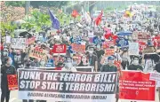  ??  ?? UNITED AS ONE: Protesters march against an antiterror­ism bill at a university campus in Manila last month.