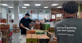  ??  ?? Volunteer Ziggy Ziya and Wellington City operations manager Martin Andrews sorting food at food rescue Kaibosh.