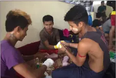  ??  ?? Lethwei fighters prepare for a bout.