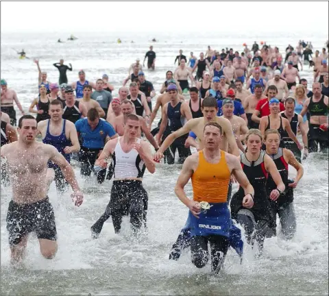  ??  ?? Kieran Gallagher (front, left) together with all the other competitor­s complete the first section in the Blackrock Crosscause Triathlon.