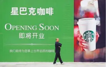  ?? Reuters ?? A giant billboard of Starbucks in Wuhan, Hubei province, China. The push in the China market comes as Starbucks stores in the US face fierce competitio­n.