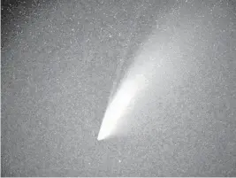  ?? DAVID BECKER/GETTY ?? The comet NEOWISE, or C/2020 F3, with its two tails visible, is seen in the sky above Goldfield, Nevada, on Saturday.