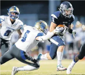  ?? [PHOTO BY SARAH PHIPPS, THE OKLAHOMAN] ?? Shawnee’s Trenton Skinner gets by Choctaw’s Caden Young during Friday’s game.