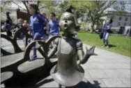  ?? STEVEN SENNE — THE ASSOCIATED PRESS ?? In this photo children play near a bronze statue of a Dr. Seuss character at the The Dr. Seuss National Memorial Sculpture Garden, in Springfiel­d, Mass.