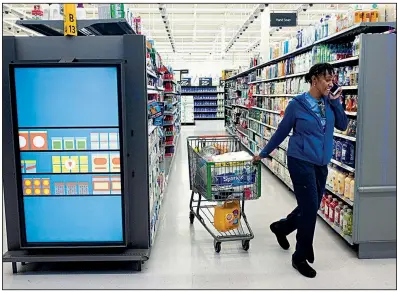  ?? AP ?? A customer shops at a Walmart Neighborho­od Market in Levittown, N.Y., in April. The consumer price index, a closely watched measure of U.S. inflation, rose 0.1% in May, reinforcin­g the case among investors for the Federal Reserve to cut interest rates.