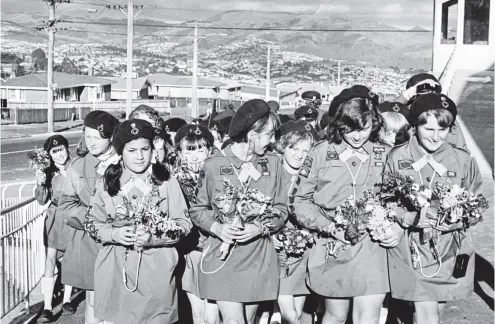  ?? PHOTO: OTAGO DAILY TIMES FILES ?? The Brockville Girl Guides’ end of year function in 1978 empasised charity when they made posies and gave them to residents at the Little Sisters of the Poor home, which had recently moved into their suburb. Leading the party of guides into the home are from left, Marlene Sua, Lyn Thompson, Elaine Luskie and Loraine Kensington.