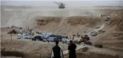  ?? (Amir Cohen/Reuters) ?? RESCUE SERVICE personnel operate near the site where 10 Israeli youths were swept away by a flash flood south of the Dead Sea on April 26.