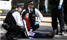  ?? ?? Police officers detain an activist who had scaled the oil tanker. Photograph: Henry Nicholls/Reuters