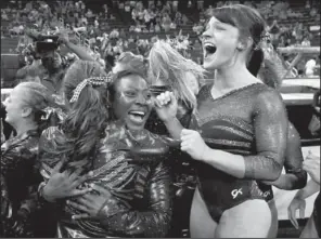  ?? AP/JOHN BAZEMORE ?? Alabama gymnasts celebrate their second consecutiv­e NCAA title after scoring 197.850 on Saturday in Duluth, Ga. Florida finished a close second at 197.775, while Arkansas was sixth at 196.300.