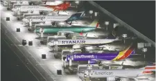  ?? GARY HE/REUTERS ?? Boeing 737 Max airplanes are seen parked at Boeing Field in Seattle. The plane maker has cut production of the Max.