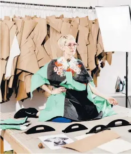  ?? EVAN JENKINS/THE NEW YORK TIMES ?? Abigail Glaum-Lathbury wears fabric printed with an image of her wearing a Gucci garment that she’ll make into a dress April 8 in her Chicago studio.