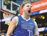  ?? MIKE STEWART / ASSOCIATED PRESS ?? Dallas Mavericks guard Luka Doncic celebrates during Friday’s game against the Hawks in Atlanta. Doncic scored 73 points in the Mavs’ win.