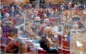  ?? AP ?? Members of Germany’s Bavarian state parliament listen to a speech from behind plastic partitions in Munich yesterday. Germany’s federal and state government­s have decided on a partial lockdown starting tomorrow.