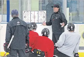  ?? THE NIAGARA FALLS REVIEW ?? Niagara Falls Canucks owner-head coach Frank Pietrangel­o, right, likes to see how prospects play under game conditions.