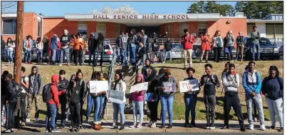  ?? Arkansas Democrat-Gazette/JOHN SYKES JR. ?? Students at Hall High School in Little Rock take part in a walkout Wednesday morning in remembranc­e of victims killed last month during a school shooting in Parkland, Fla., and to call for more gun control.