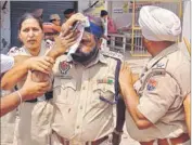  ??  ?? DSP Tilak Raj being taken to a hospital after getting injured in stone pelting by protesters at Ajnala, near Amritsar, on Sunday. HT PHOTO