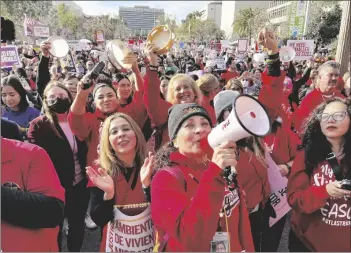  ?? FRANCINE ORR/LOS ANGELES TIMES VIA AP ?? Sylvia Garcia, from Bassett Street Elementary, talks as she and other teachers attend a Los Angeles Unified School District and Service Employees Internatio­nal Union 99 (SEIU) rally in Grand Park in downtown Los Angeles, on March 15.