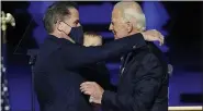  ?? AP PHOTO/ANDREW HARNIK, POOL ?? In this Nov. 7 file photo, President-elect Joe Biden, right, embraces his son Hunter Biden, left, in Wilmington, Del. Biden’s son Hunter says he has learned from federal prosecutor­s that his tax affairs are under investigat­ion.