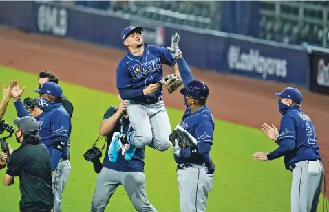  ?? GREGORY BULL/ASSOCIATED PRESS ?? Tampa Bay Rays shortstop Willy Adames jumps in the air while celebratin­g with teammates after defeating the Yankees in Game 3 of an American League Division Series on Wednesday in San Diego.