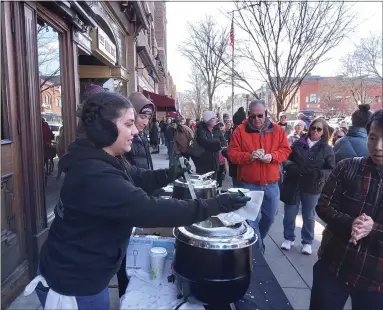  ?? MELISSA SCHUMAN - MEDIANEWS GROUP ?? Sam Varin, left, serves up The Merc’s smoked New England clam chowder.