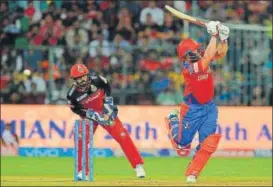  ?? AFP ?? Royal Challenger­s Bangalore wicket keeper Kedar Jadhav (left) looks on while Gujarat Lions’ Aaron Finch (rihgt) plays a shot at Bangalore on Thursday.