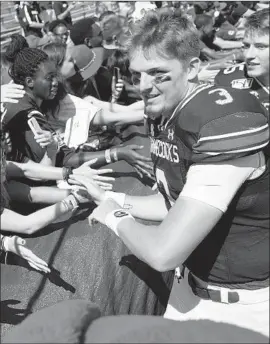  ?? John Amis Associated Press ?? RYAN HILINSKI can smile after his first start as South Carolina’s quarterbac­k, as the freshman from Orange Lutheran led a 72-10 win over Charleston Southern.