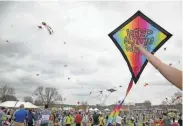  ?? AMERICAN-STATESMAN JAY JANNER / ?? Monica Little launches her kite at the ABC Kite Festival in 2016 in Zilker Park. Thousands of kite fliers and spectators participat­ed in the event, which was first held in 1929 and is the longest continuous­ly running kite festival in the United States.