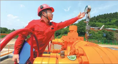 ?? ZHONG MIN / FOR CHINA DAILY ?? A worker from China National Petroleum Corp checks the figures on a gauge.