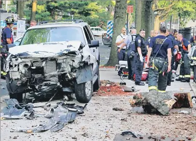  ??  ?? ‘OH, MY GOD, MY GRANDCHILD­REN’ The critically injured 74-year-old driver of a sedan struck by this SUV in Bayside Wednesday was heard moaning for family members, two of whom were killed.